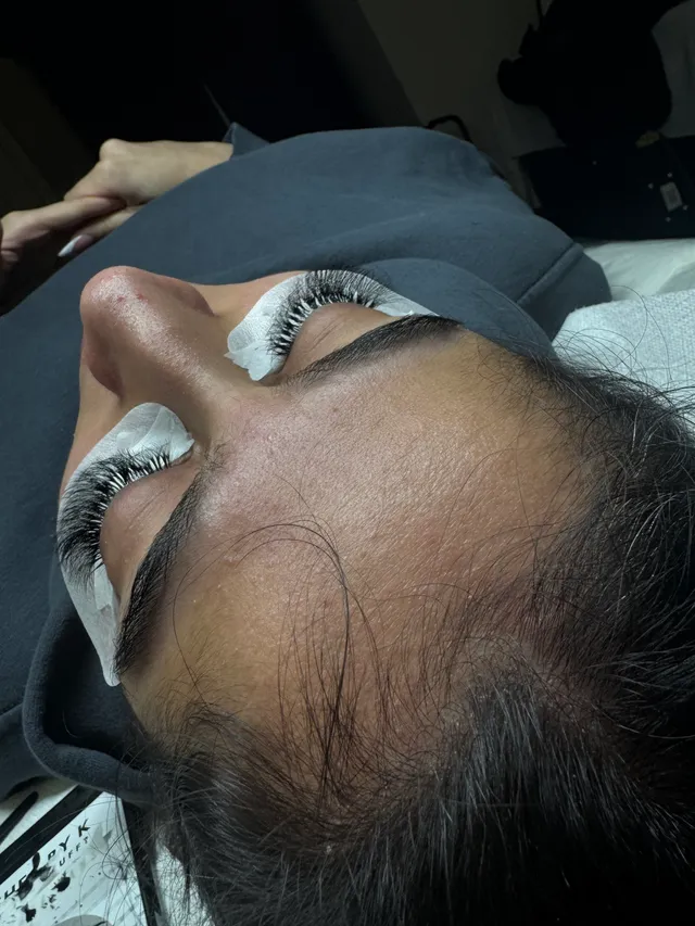 Lash set in progress with under eye pads in Sahej’s lash chair